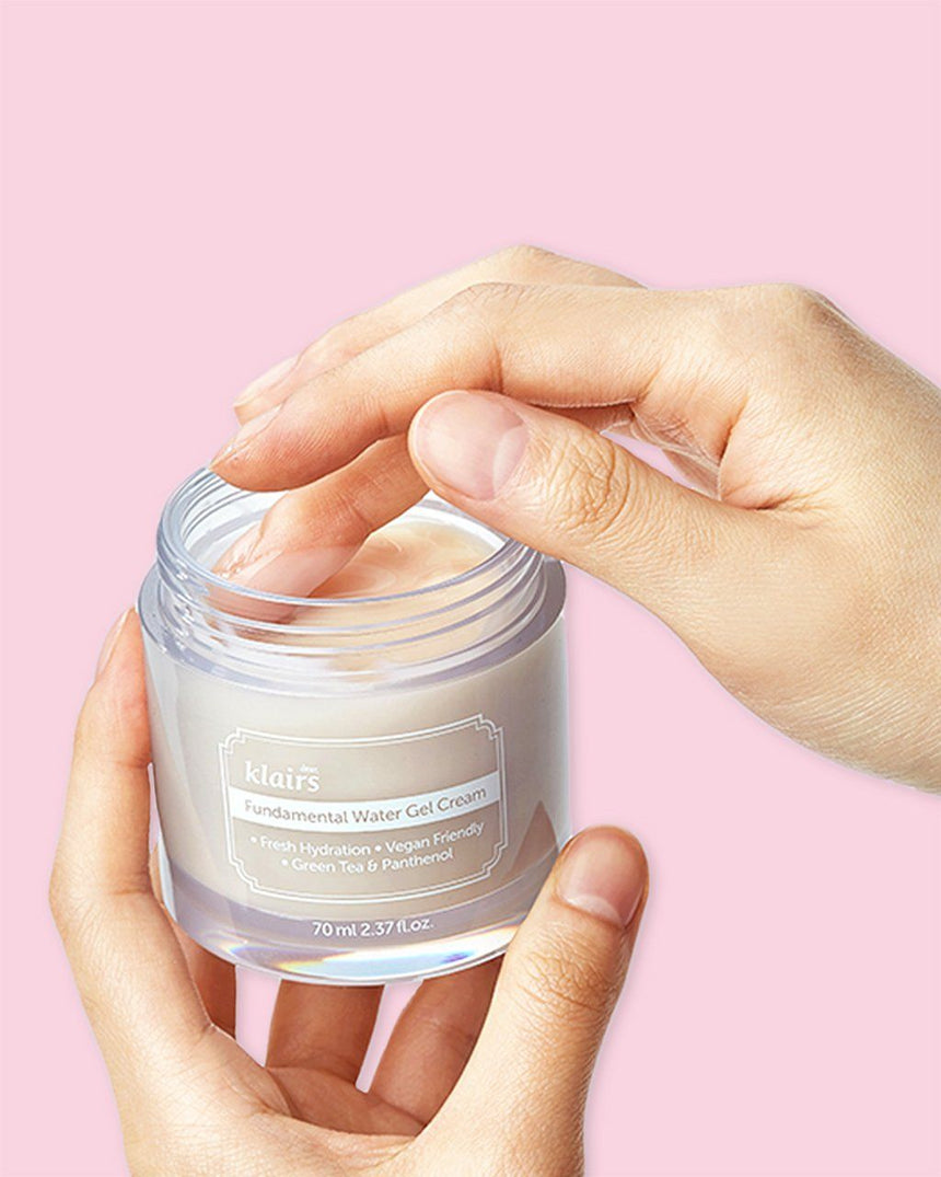 a hand scooping KLAIRS Fundamental Water Gel Cream 