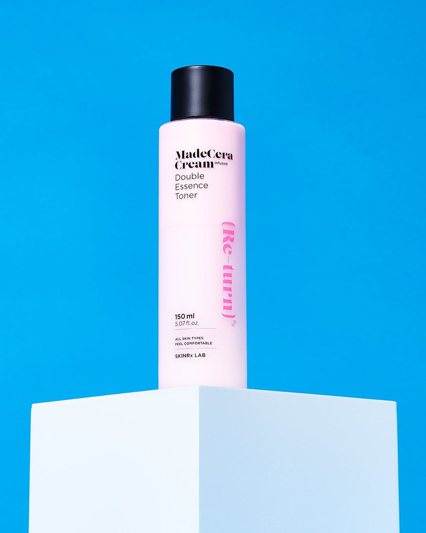 MadeCera Cream Double Essence Toner on a pedestal with blue background