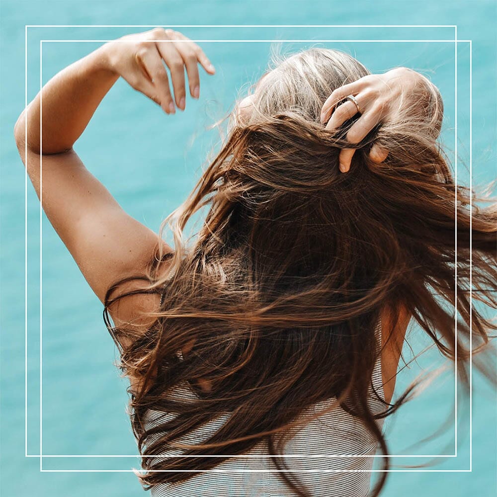 How To Protect Your Hair From Sun Damage This Summer- And All Year Long